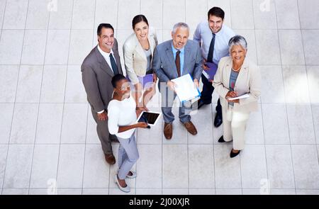 Theyre a dynamic team. Shot of a group of businesspeople discussing paperwork in a meeting. Stock Photo