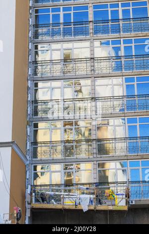 Building and Construction site of new home. House under construction at building site. Glazed balconies of house in facade. Stock Photo