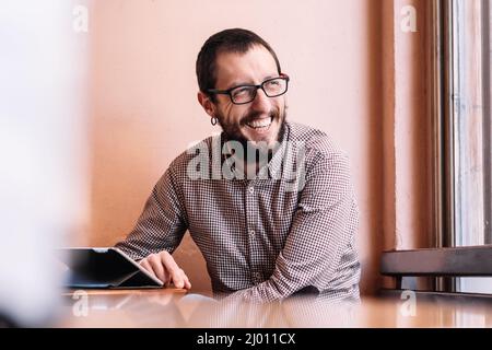 young businessman working on his tablet in a cafe shop Stock Photo