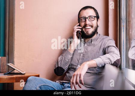 Young caucasian man smiling happy talking on the smartphone Stock Photo