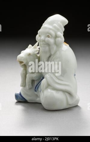 Water Dropper in the Form of Fukurokuju with His Deer. Japan, 19th century. Ceramics. Hirado ware; porcelain with white and blue glazes Stock Photo