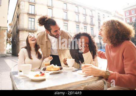 People group talking at coffee bar terrace. Friends having fun together at cafeteria on brunch time. Lifestyle concept with happy men and women at Stock Photo