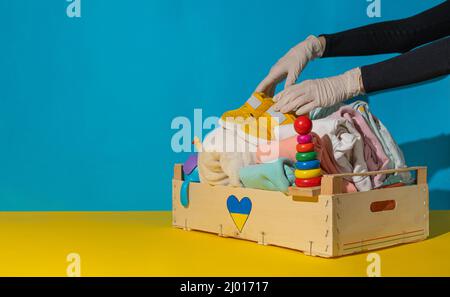 Donation box with children's things and toys for Ukrainian refugees. Stock Photo