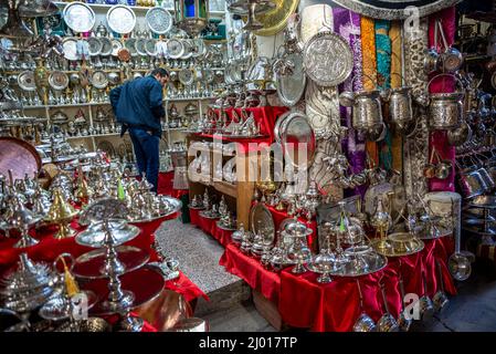 A customer checking the goods on sale in a silver shop in the Medina (old city) of Tunis, Tunisia.