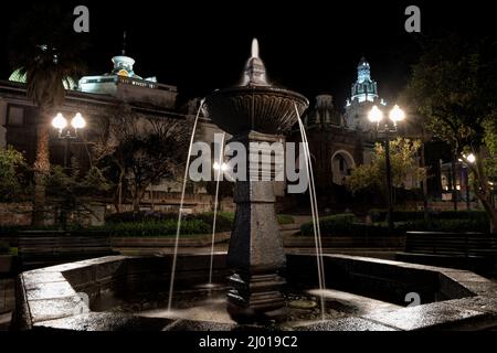 Fountain on Independence Square (Plaza Grande) with Metropolitan Cathedral (Catedral Metropolitana de Quito) in the background, Quito, Ecuador Stock Photo