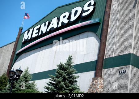 Menards Store for home improvement and building materials flying the American Flag with evergreens in the front patio. Blaine Minnesota MN USA Stock Photo