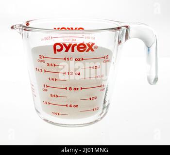 Oil in measuring cup isolated on white background Stock Photo