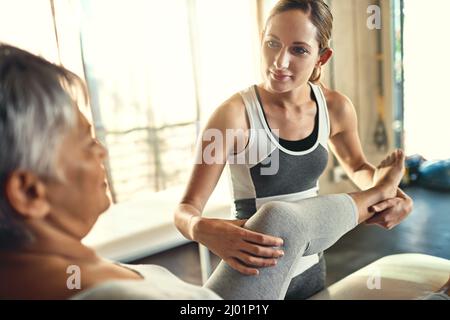 Shell happily assist you in your time of need. Shot of a senior woman being treated by a physiotherapist. Stock Photo