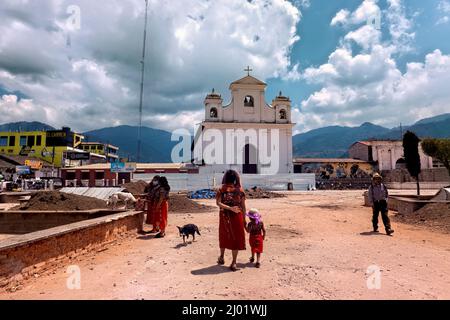 Ixil women in front of the church and main plaza, Nebaj, El Quiché, Guatemala Stock Photo