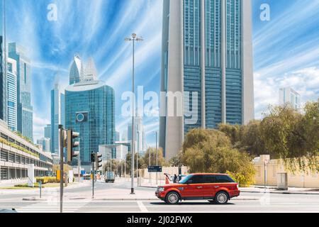 Dubai, UAE, United Arab Emirates - May 28, 2021: Red Range Rover (L322) suv car parked at street against blue and white sky. Range Rover (L322) is Stock Photo
