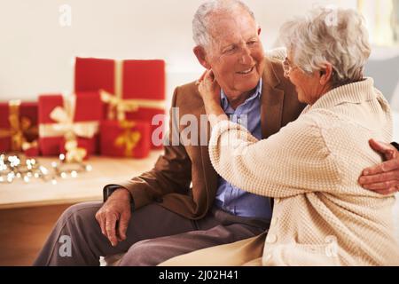 We love the holidays. Portrait of an affection senior couple at Christmas. Stock Photo