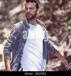 Walking around in style. Shot of a fashionable young man walking outside. Stock Photo