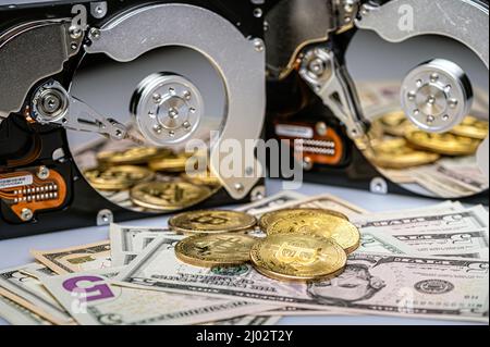 Bitcoin BTC coins, open hard drive and dollar bills, cryptocurrency and digital payment system Stock Photo