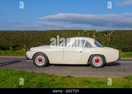 1963 60s sixties White Ford Falcon 1172cc, hardtop coupé body en-route to Capesthorne Hall classic August car show, Cheshire, UK Stock Photo