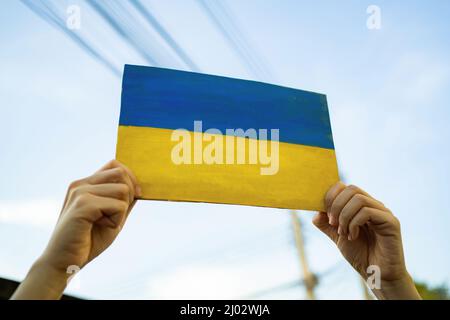 A man holding cardboard painted into Ukraine flag Stock Photo