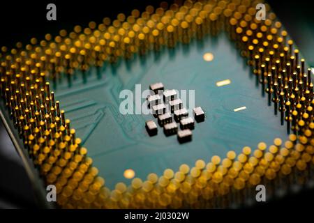 Macro Close up of microchips and pins on Main CPU PC processor circuit board. Stock Photo