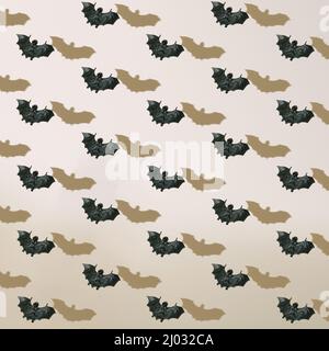 Halloween pattern of black flying bats with shadows on neutral beige background. Stock Photo