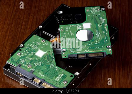 Computer hard drives on a polished wooden surface Stock Photo
