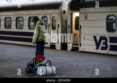 Kyiv, Ukraine. 13th Mar, 2022. A young girl is seen with her luggage at the railway station in Kyiv as she waits for the evacuation train. The European Union has put in place a temporary protection mechanism for Ukrainian refugees who were forced to leave Ukraine due to the Russian invasion. Refugees were allowed to legally live and work in EU countries for up to three years. (Credit Image: © Mohammad Javad Abjoushak/SOPA Images via ZUMA Press Wire) Stock Photo