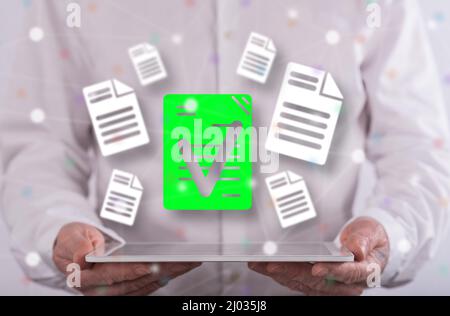 Document validation concept above a tablet held by a man in background Stock Photo