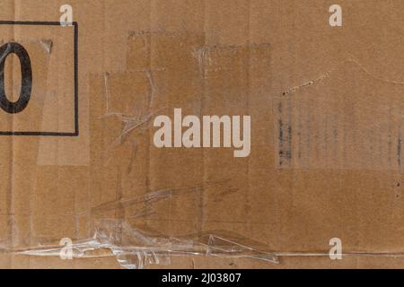 Worn cardboard texture with clear tape Stock Photo