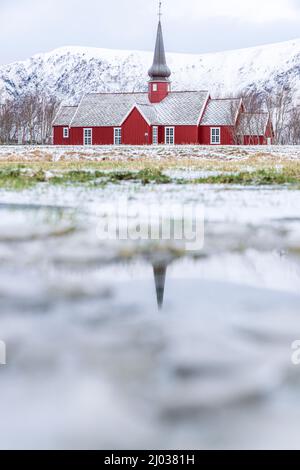 Church of Flakstad reflected in a pond in winter, Nordland county, Lofoten Islands, Norway, Scandinavia, Europe Stock Photo