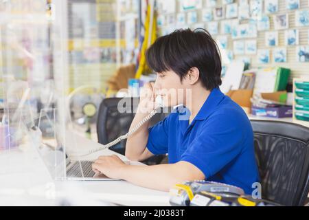 sale shop reception staff on phone call with customer support for hot line contact Stock Photo