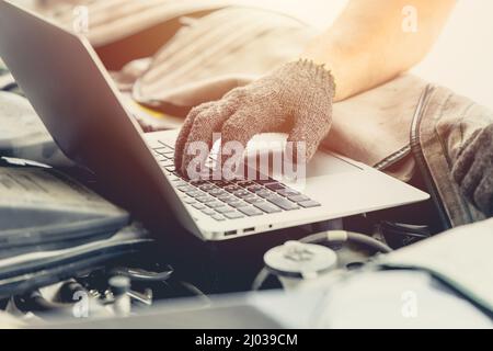 closeup engineer service professional using laptop computer tuning car engine Stock Photo