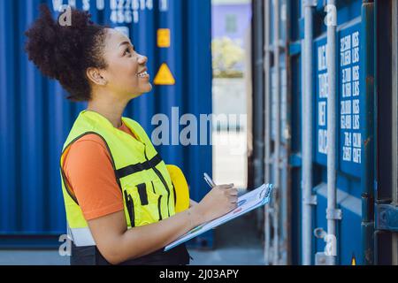 working women happy staff worker  enjoy work checking container for delivery in logistic industry Stock Photo