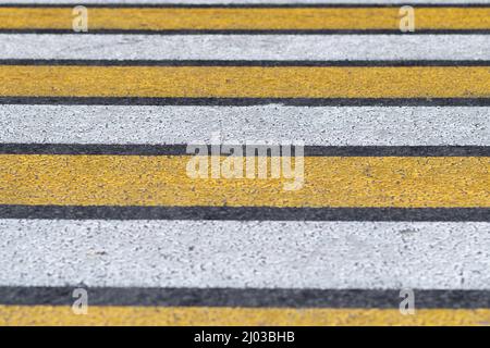 Designation of an unregulated pedestrian crossing in high-risk areas. Pedestrian zebra yellow-white Stock Photo