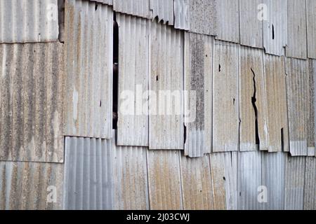 The facade of the shed is made of rusty slate. Sheets of old slate Stock Photo