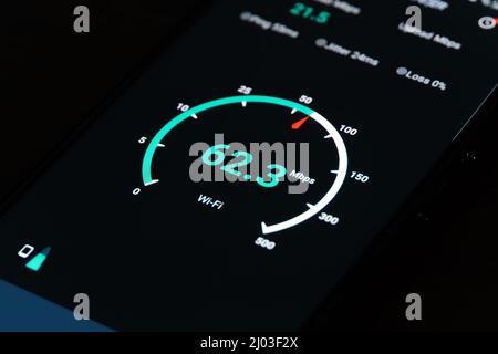 Close-up of the result of checking the Internet speed on a mobile phone on a black background Stock Photo