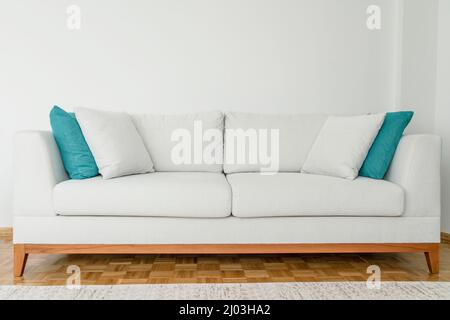 couch sofa, new cozy and modern sofa or couch in the living room with carpet on the parquet floor at home interior Stock Photo