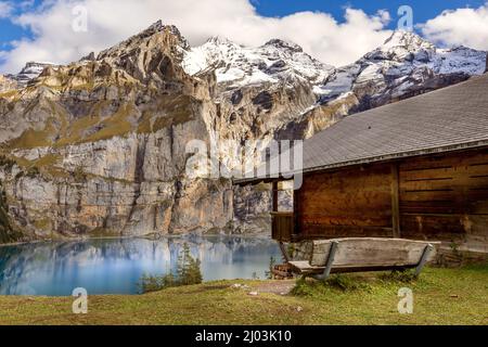 Amazing tourquise Oeschinnensee lake, wooden chalet and Swiss Alps, Berner Oberland, Switzerland. Stock Photo