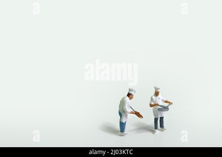 two cooks in work clothes isolated on white background Stock Photo - Alamy