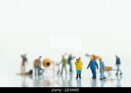 a team of construction workers, in the background other workers Stock Photo