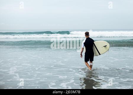 young man goes surfing. high quality photo Stock Photo