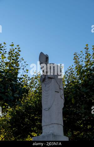 Vertical shot of the Statue of Saint Denis in Place Suzanne Buisson Stock Photo