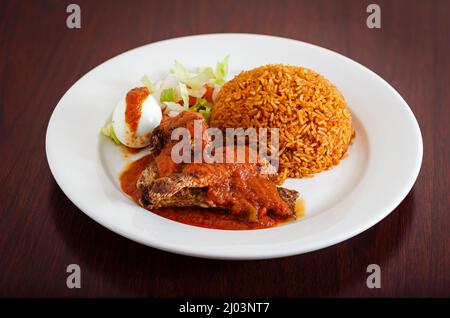 https://l450v.alamy.com/450v/2j03nt7/classic-ghanaian-meal-of-jollof-rice-fish-covered-in-red-sauce-and-boiled-egg-2j03nt7.jpg