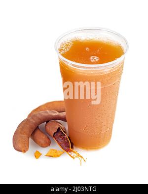 Cool refreshing Tamarindo drink with pods on a white background; copy space Stock Photo