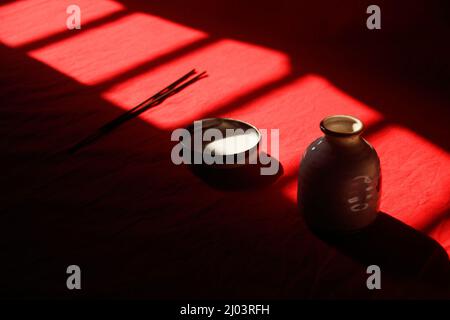 Light and shadows cast on ceramic incense holder showing the concept of mindfulness, tranquility and life balance Stock Photo