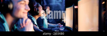 Professional team playing esports game on computers in internet club Stock Photo