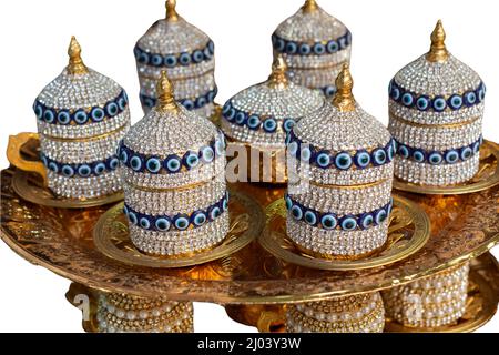 Turkish Evil Eye teacups and saucer holder with lids and tray isolated on a white background Stock Photo