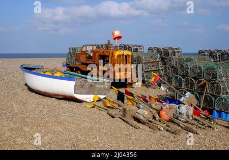 fishing boat, tractor and lobster pots on cley-next-the-sea beach, north norfolk, england Stock Photo