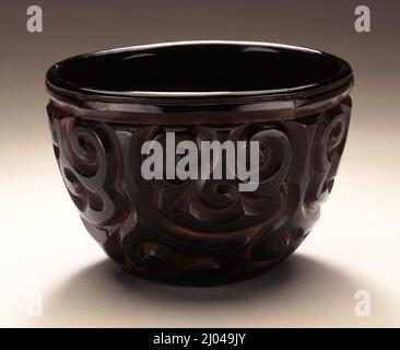 Tea Bowl (Chawan) with Sword-Pommel Pattern. China, Late Southern Sung dynasty or early Yuan dynasty, about 1200-1368. Furnishings; Serviceware. Carved black and red lacquer on wood core Stock Photo