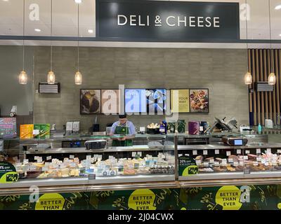 Deli and cheese in Waitrose Rushden Northamptonshire UK food exotic type eating displayed containers staff helping sign signs staff working artwork Stock Photo