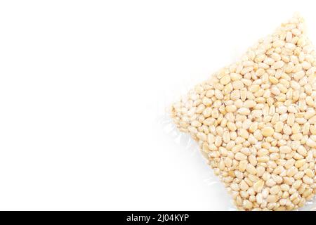 Pine nuts in a transparent vacuum package over a white background Stock Photo