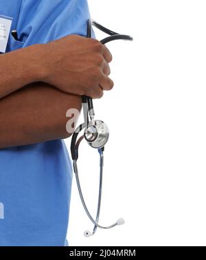 Taking matters of health seriously. Cropped view of a medical resident with his arms folded and holding a stethoscope in his one hand. Stock Photo