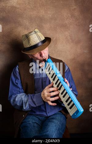 adult man playing the melodica Stock Photo