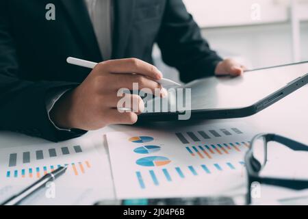 Closeup businessman hand using tablet computer at work Stock Photo